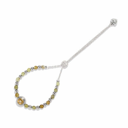 Brighton beaded bracelet with green stones, silver-tone beads, gold medallion accent, and adjustable chain on a white background