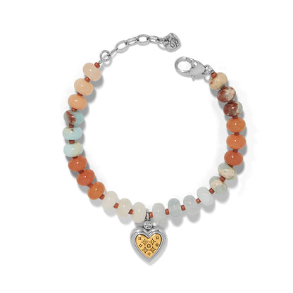 Brighton beaded bracelet with multicolor stone beads and silver-plated heart charm with gold accent on a white background