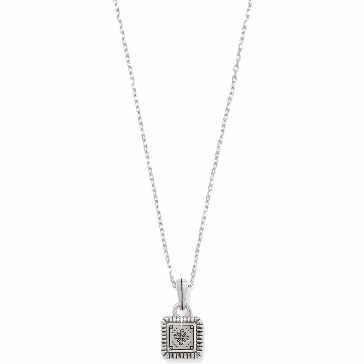 Brighton pendant necklace with small square silver-tone charm featuring engraved floral motif and ridged border on a white background
