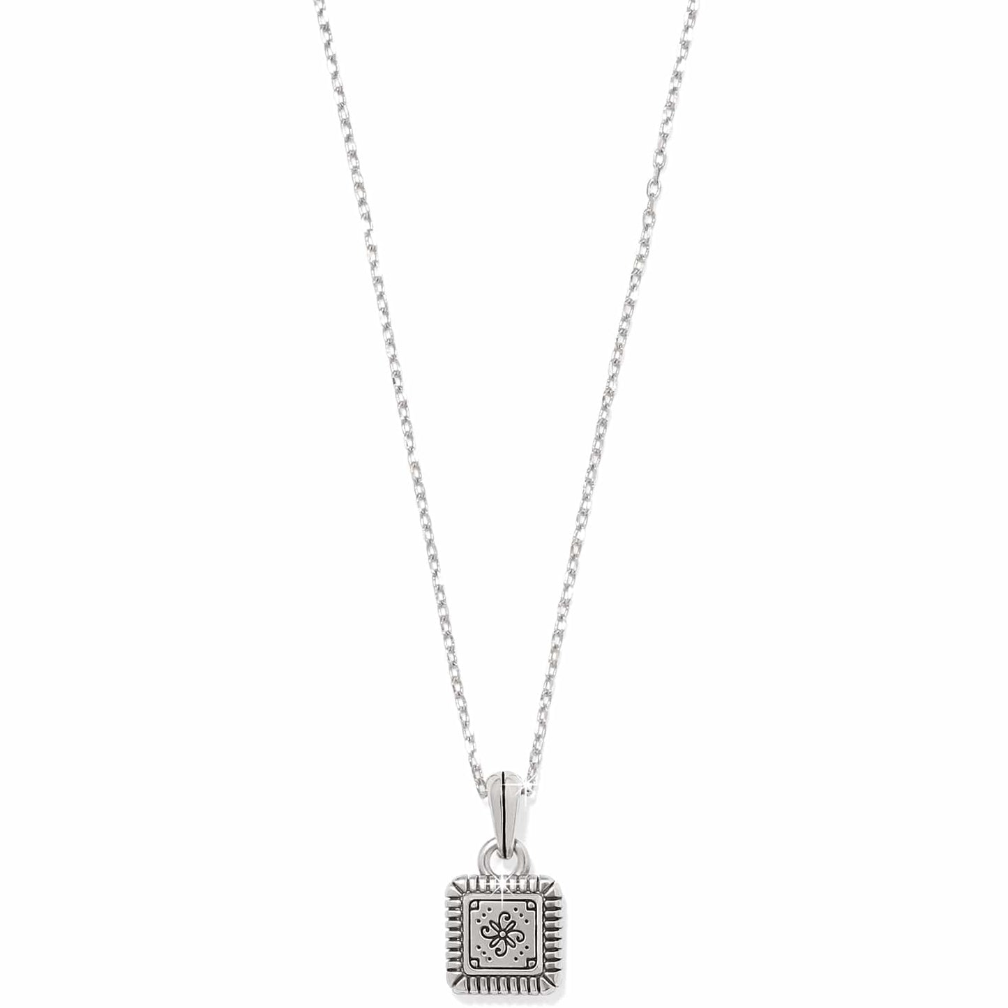Brighton pendant necklace with small square silver-tone charm featuring engraved floral motif and ridged border on a white background