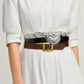 Model wearing three Brighton leather belts with silver studded strap, black croc-embossed heart buckle, and brown tooled design
