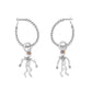 Brighton hoop earrings with silver-plated twisted rope design and dangling skeleton charms with enamel flowers on a white background