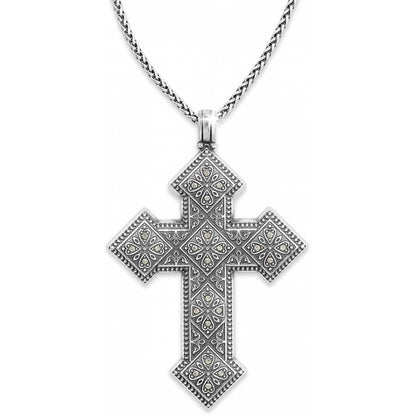 Brighton pendant necklace with ornate silver-plated cross featuring floral engravings, crystal accents, and woven chain on a white background