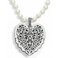 Brighton pendant necklace with silver-plated filigree heart, crystal bail, and glass pearl strand on a white background