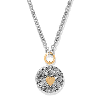 Brighton pendant necklace with two-tone crystal-pavé disc, gold heart accent, and silver-tone chain on a white background