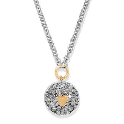 Brighton pendant necklace with two-tone crystal-pavé disc, gold heart accent, and silver-tone chain on a white background
