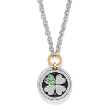 Brighton pendant necklace with silver four-leaf clover, green crystal heart, and gold-tone accent ring on a white background