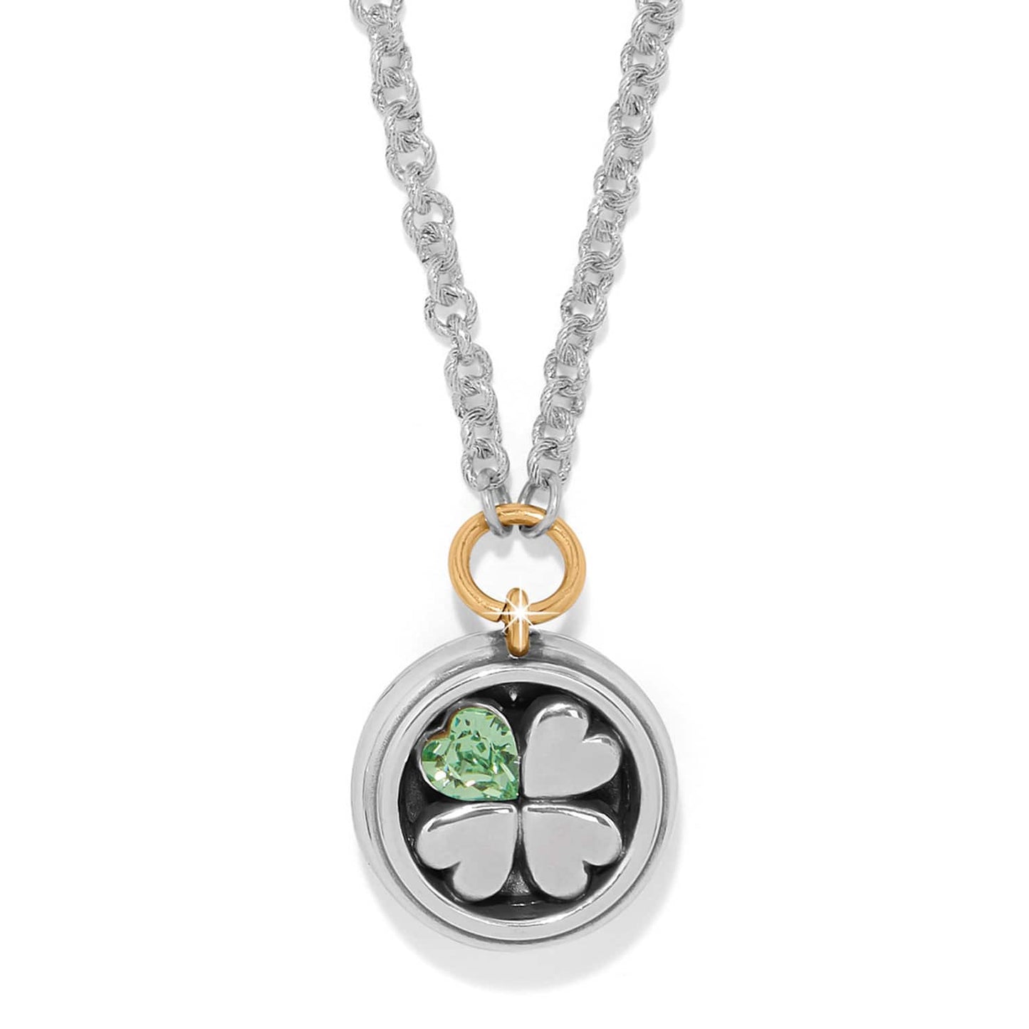 Brighton pendant necklace with silver four-leaf clover, green crystal heart, and gold-tone accent ring on a white background