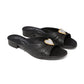 Brighton black leather slide sandals with silver and gold-tone heart ornament and low heel on a white background