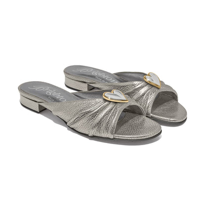 Brighton silver metallic leather slide sandals with gold-trimmed heart accent and low block heel on a white background
