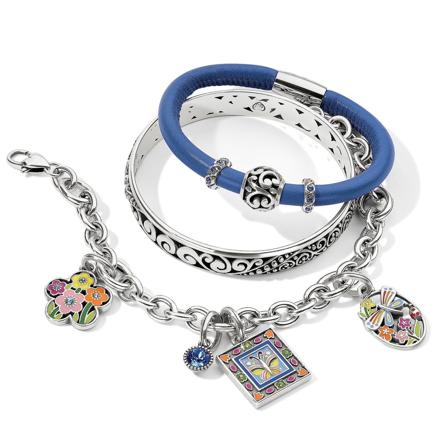 Brighton silver-plated bracelets with blue leather band, scroll bangle, and enamel floral butterfly charms on a white background