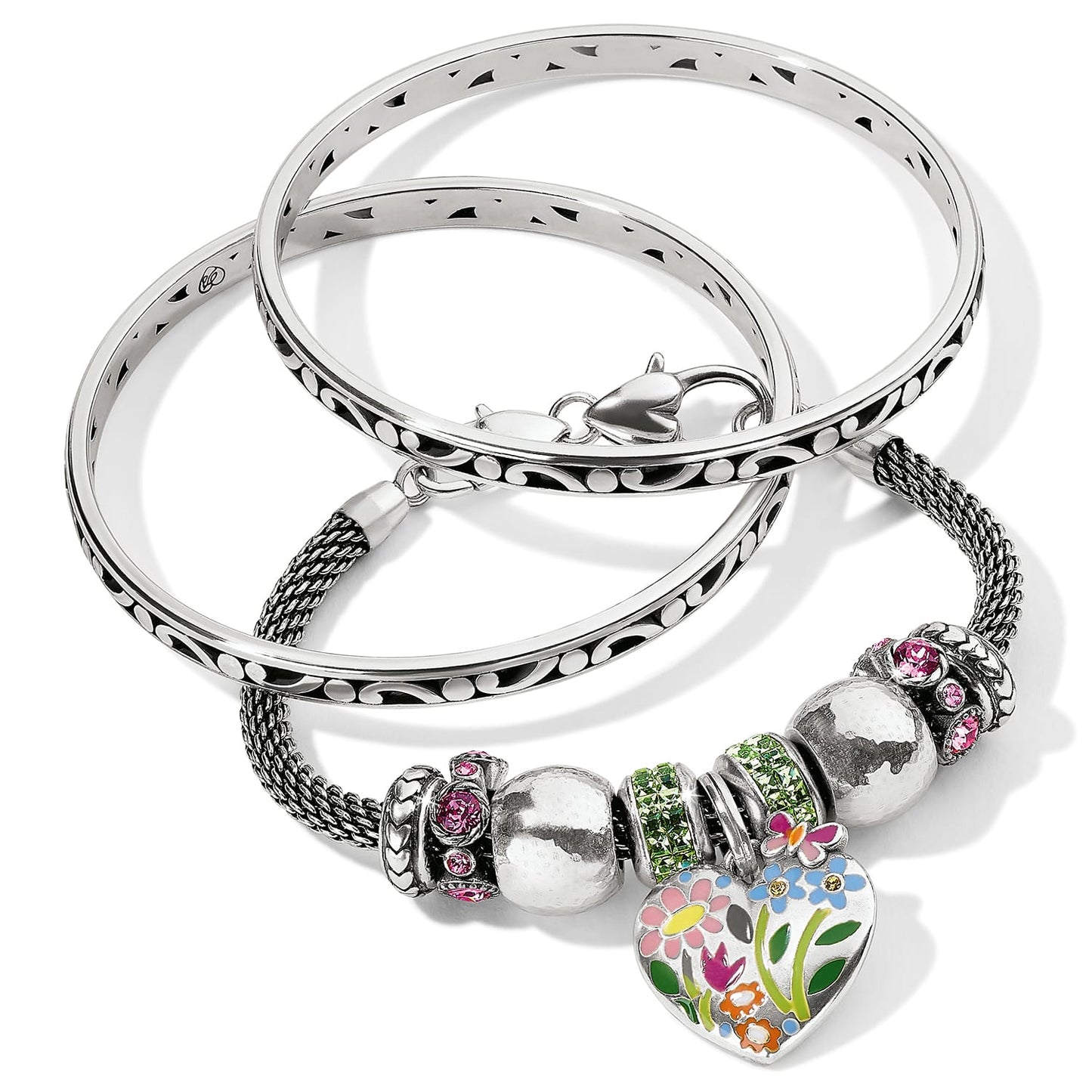 Brighton silver-plated bracelet set with two engraved bangles and mesh charm bracelet featuring enamel floral heart on a white background