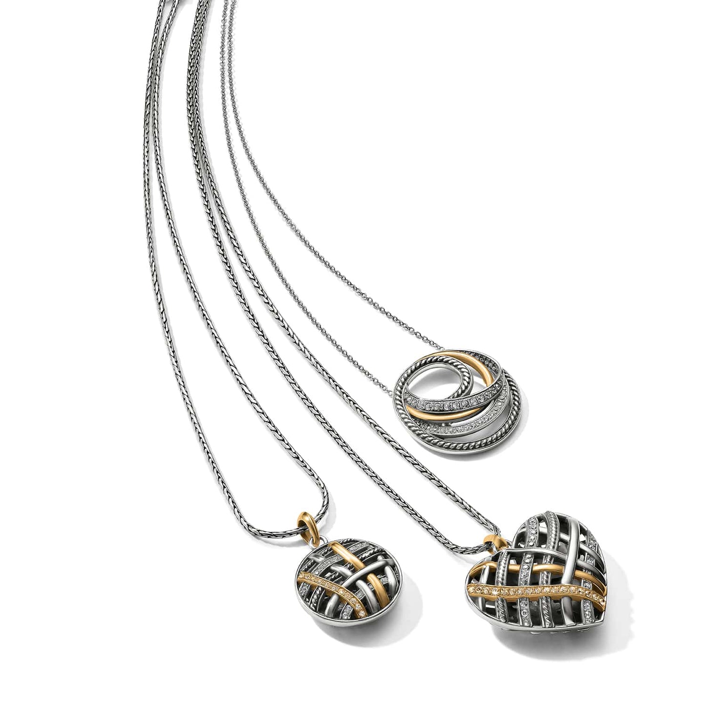 Brighton silver-plated necklaces with woven heart pendant, oval pendant, and interlocking rings with crystals on a white background