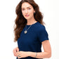 Model wearing a Brighton silver-plated heart pendant necklace with crystals, paired with matching hoop earrings and bangles