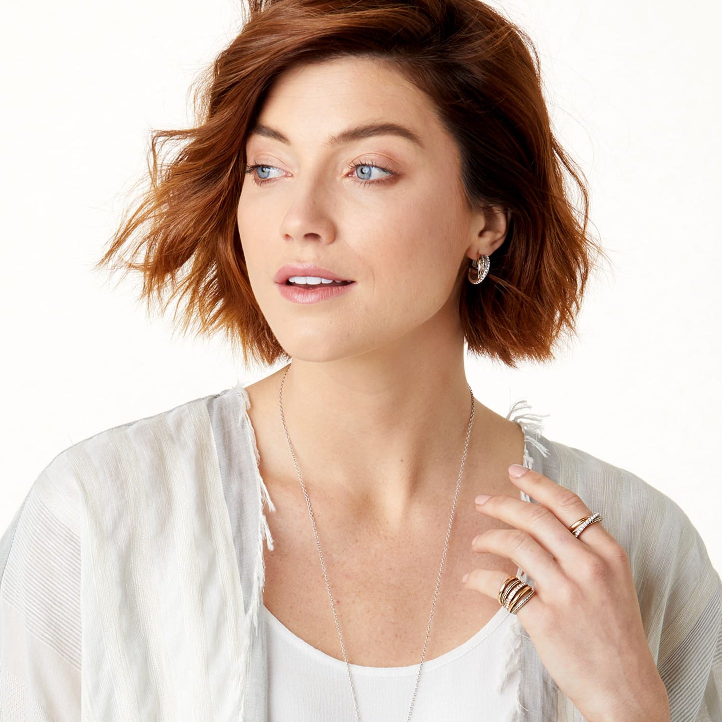 Model wearing Brighton two-tone hoop earrings with a long silver-tone chain necklace and coordinating Brighton rings