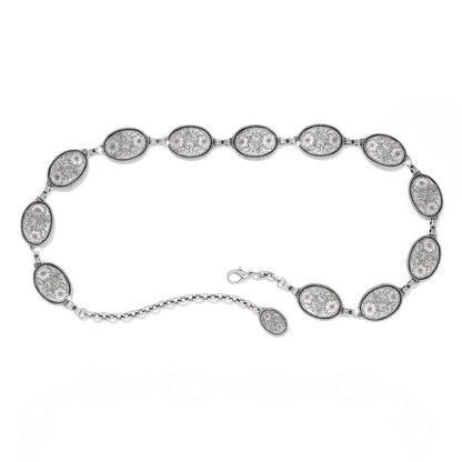 Brighton chain belt with oval engraved silver-tone medallions, floral scroll detail, and lobster clasp closure on a white background