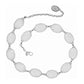 Brighton belt with linked oval silver-tone medallions and engraved oval pendant on chain on a white background