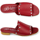 Brighton red leather slide sandals with silver-tone studded strap shown from top and side views on a white background
