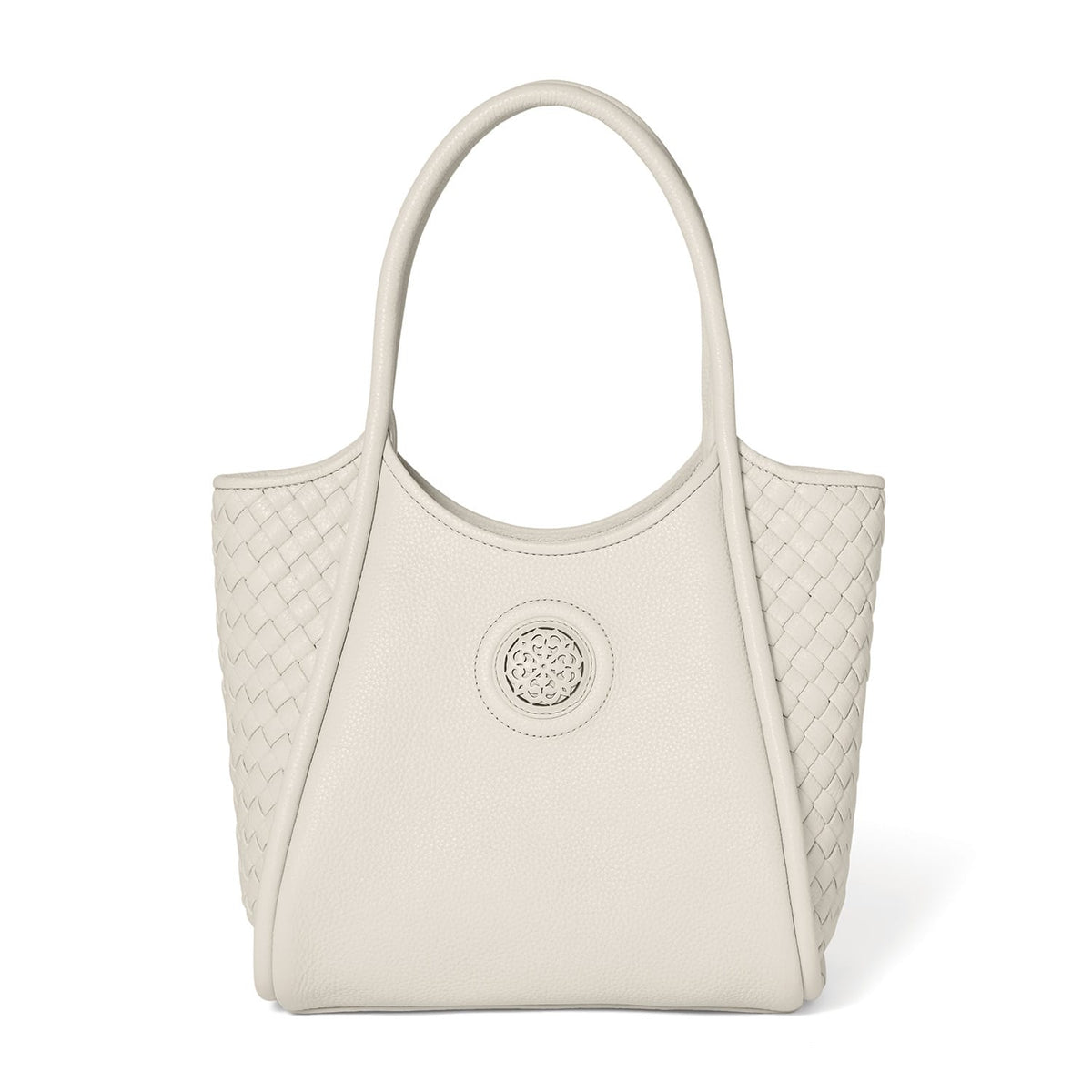 Brighton tote handbag in cream leather with woven side panels, circular medallion emblem, and dual top handles on a white background