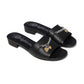 Brighton black leather slide sandals with silver-tone chain and gold heart charm accents on a white background
