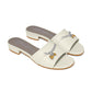 Brighton cream leather slide sandals with silver-tone chain and gold heart charm details on a white background