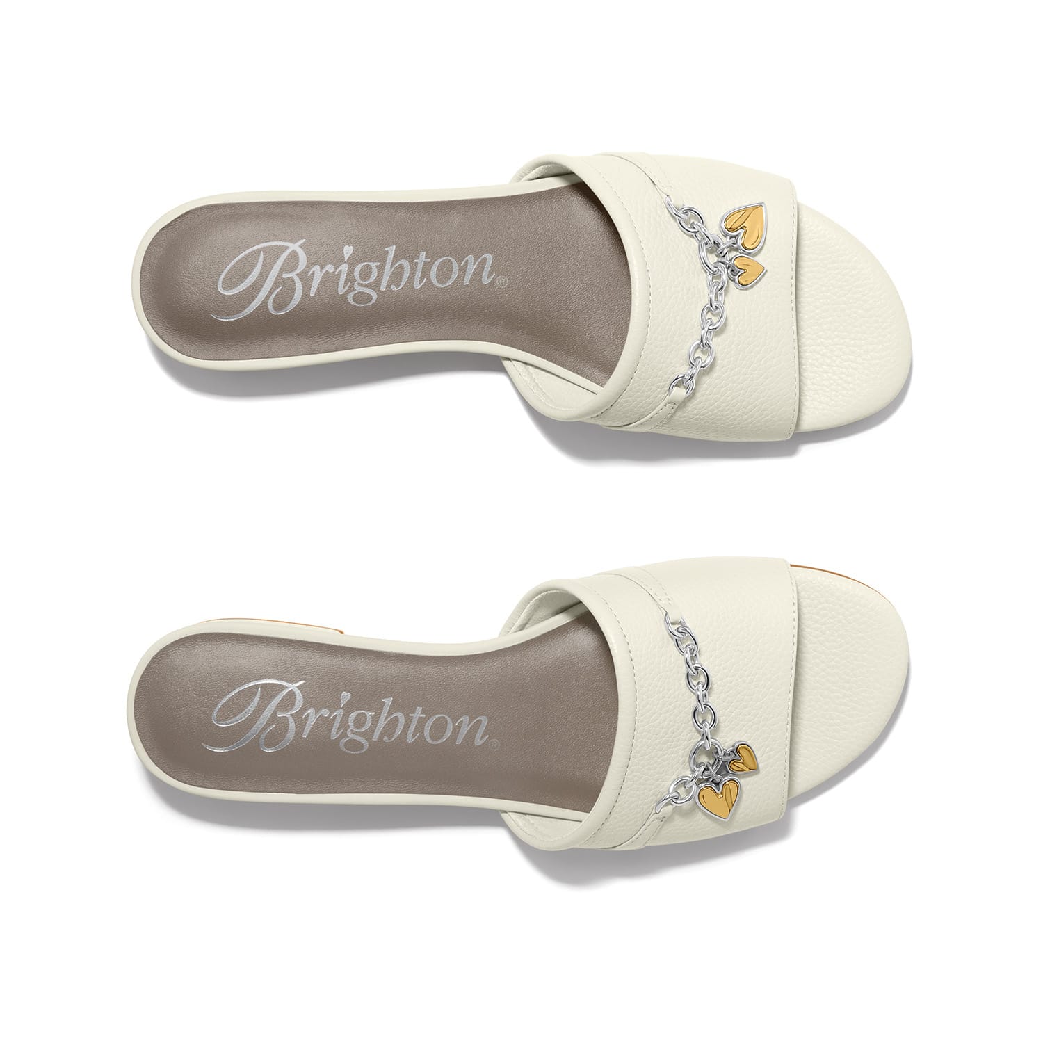 Brighton white leather slide sandals with silver-tone chain and gold heart charm accents on a white background