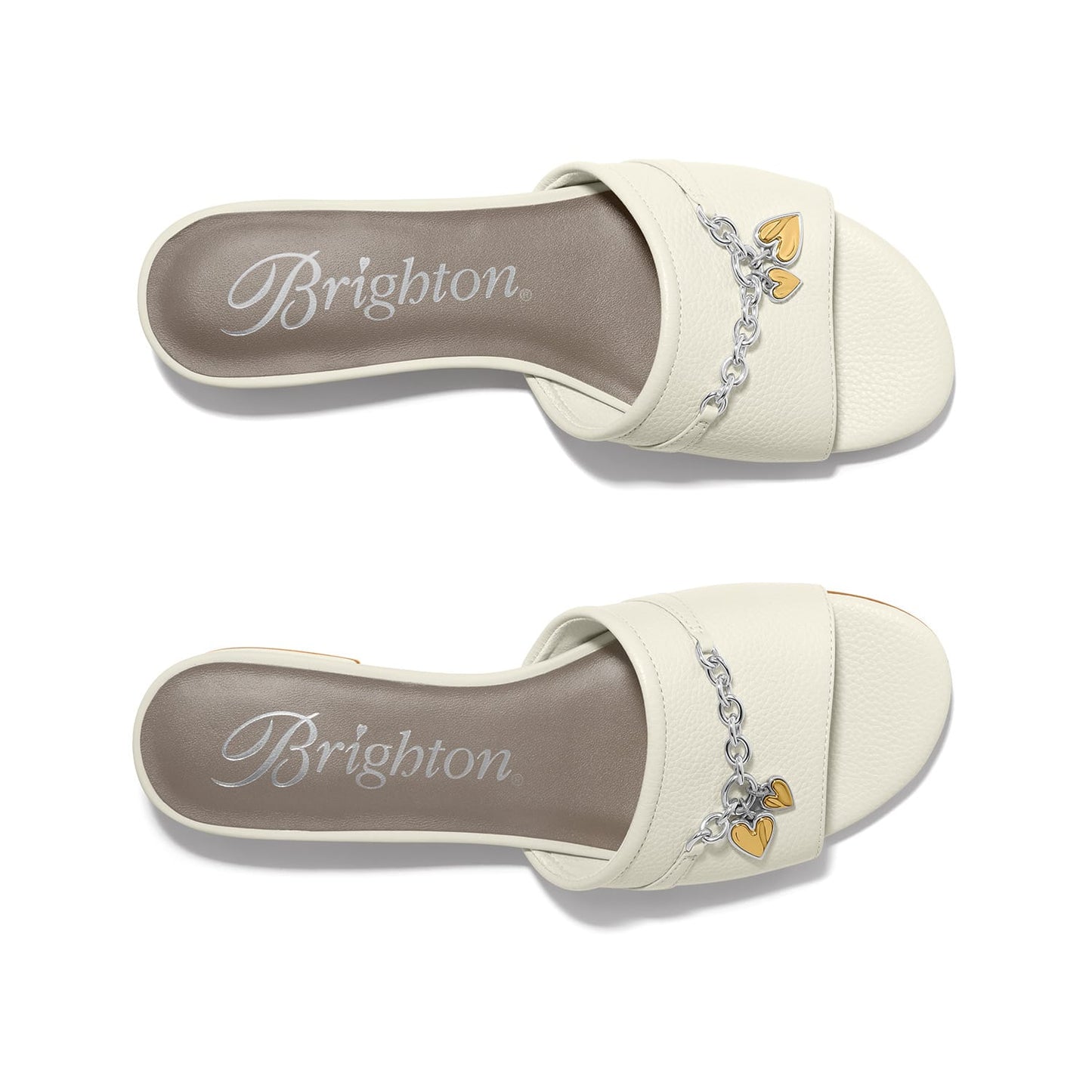 Brighton white leather slide sandals with silver-tone chain and gold heart charm accents on a white background