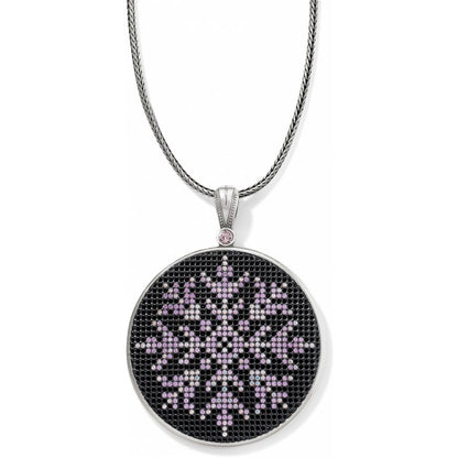 Brighton pendant necklace with silver-plated round medallion featuring pink crystal snowflake design on a white background