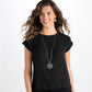 Model wearing a Brighton silver-plated pendant necklace with ornate medallion, paired with matching round drop earrings