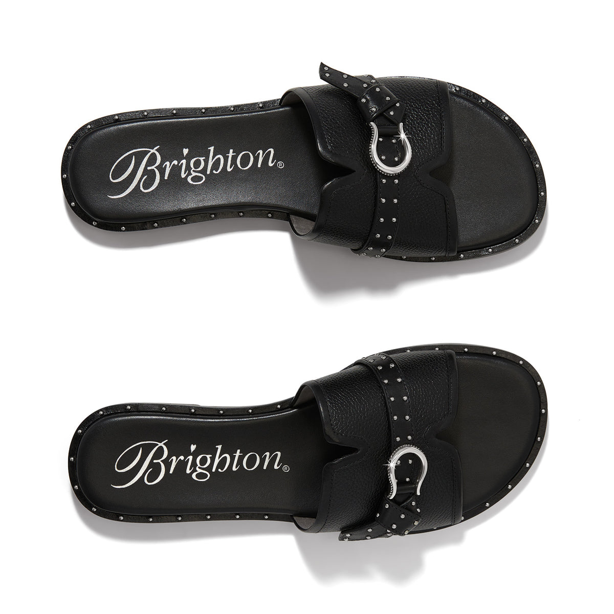 Brighton black leather slide sandals with silver-tone buckle detail and studded trim shown from above on a white background