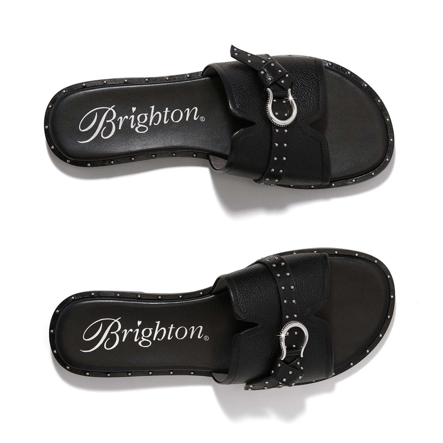 Brighton black leather slide sandals with silver-tone buckle detail and studded trim shown from above on a white background