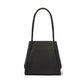 Brighton black handbag shown from the back with braided shoulder strap and slip pocket on a white background