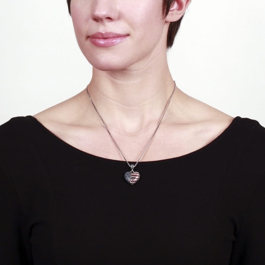 Model wearing a Brighton pendant necklace with silver-plated heart charm featuring American flag crystal design