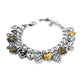Brighton charm bracelet with silver-plated heart charms, gold-tone accents, crystals, and key detail on a white background