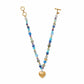 Brighton beaded necklace with multicolor heart stones, gold-plated accents, and hammered gold heart pendant on white background