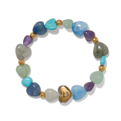 Brighton stretch bracelet with multicolor gemstone heart beads, gold-plated accents, and central two-tone heart charm on a white background