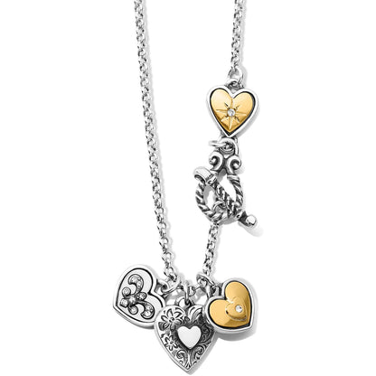 Brighton charm necklace with two-tone heart charms, crystal accents, floral engraving, and toggle clasp on a white background