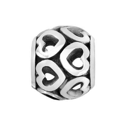 Brighton charm bead with silver-plated finish and cut-out heart designs around the barrel on a white background