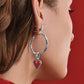 Model wearing a Brighton silver hoop earring with dangling red enamel heart charm and beaded detail