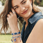 Model wearing a Brighton silver-tone link bracelet with patriotic enamel charms and coordinating Brighton accessories