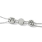 Close-up of Brighton bracelet with three silver-plated round beads featuring dot and abstract patterns on delicate chains