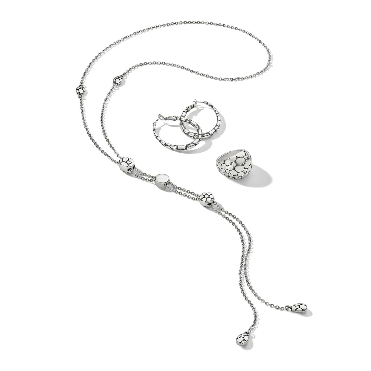 Brighton silver-plated jewelry set styled with lariat necklace, hoop earrings, and dome ring on a white background