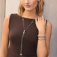 Model wearing a Brighton silver-plated lariat necklace with textured pendants and coordinating Brighton accessories