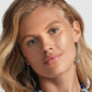 Model wearing Brighton silver-plated drop earrings with chain dangles and beaded accents paired with a blue beaded necklace