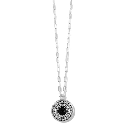 Brighton pendant necklace with silver-plated round medallion, black center stone, and paperclip chain on a white background