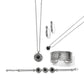 Brighton silver-plated jewelry set styled with black stone pendants, dotted cuff bracelet, hoop earrings, and beaded bracelet on white background
