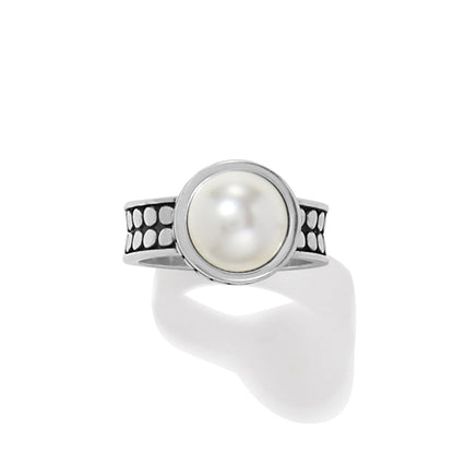 Brighton silver-plated ring with round glass pearl cabochon and dotted textured band on a white background