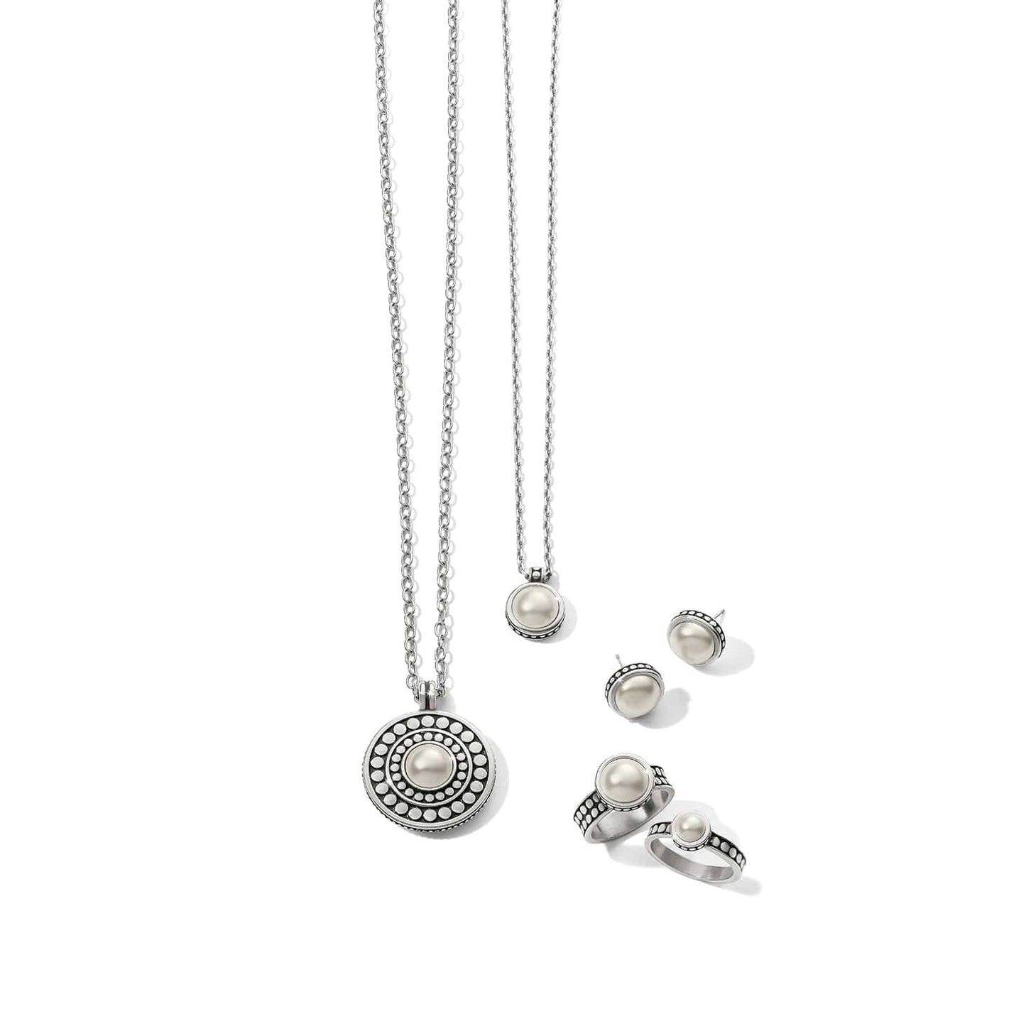 Brighton jewelry set styled with silver-plated pearl pendant necklaces, matching stud earrings, and rings on white background