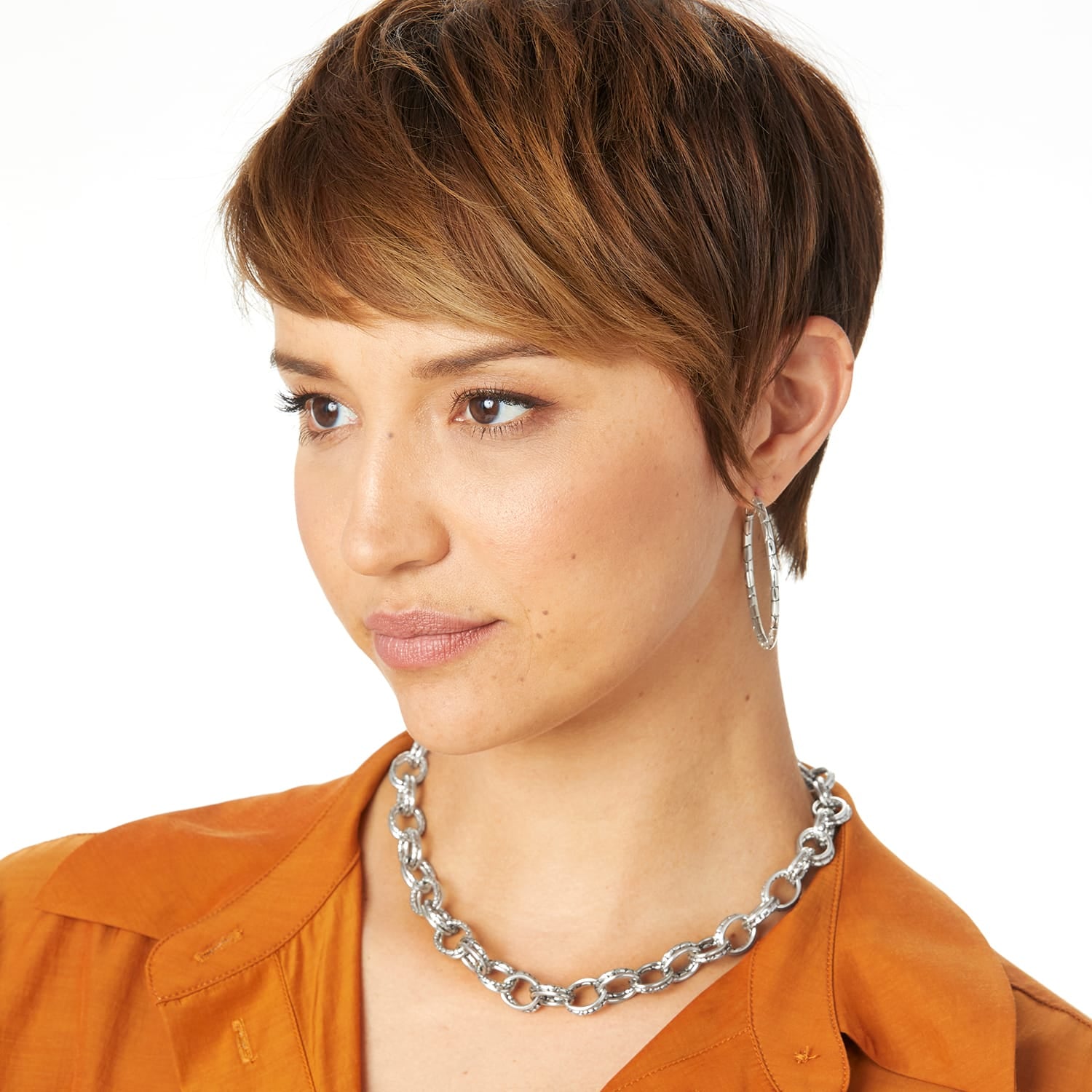 Model wearing a Brighton silver-plated chunky link chain necklace paired with textured silver-plated hoop earrings