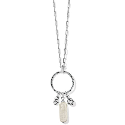 Brighton pendant necklace with silver-plated ring, chain, pearl drop, and dotted charms on a white background